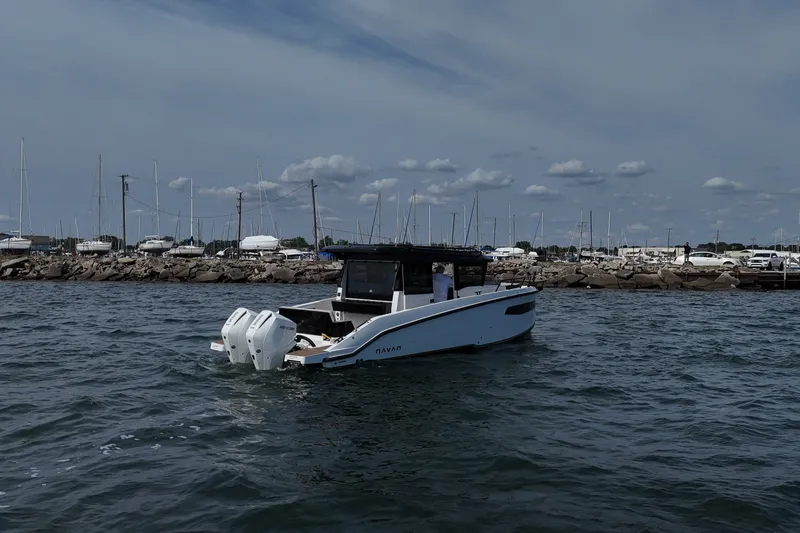 Slide: The Image of Navan C30 2026 boat on water near marina, showcasing sleek design and twin engines. - 5