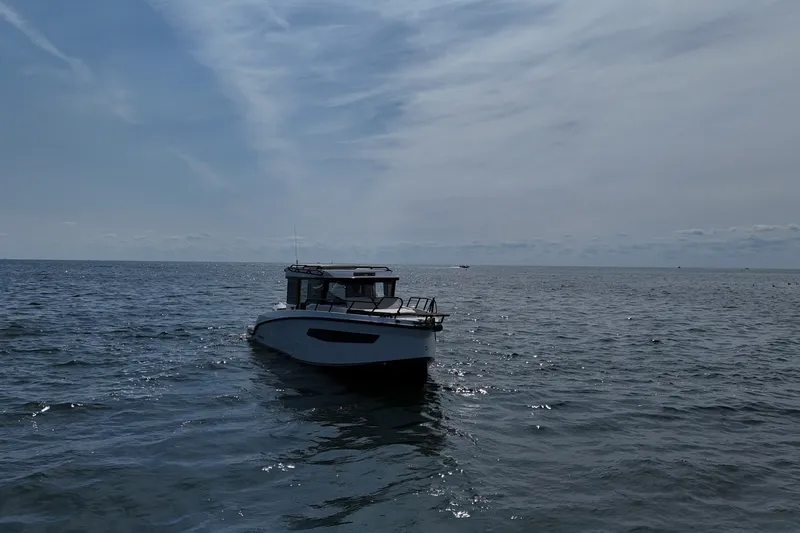 Slide: The Image of 2026 Navan C30 boat cruising on open sea under a cloudy sky. - 10