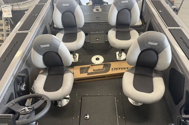 Slide: The Image of 2027 Tracker Targa V-19 Combo boat interior with four cushioned seats and steering wheel. - 4