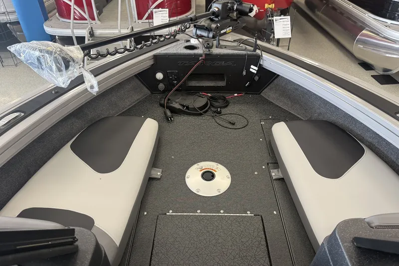 Slide: The Image of Interior of a 2027 Tracker Targa V-19 Combo boat, featuring seating and control panel. - 8