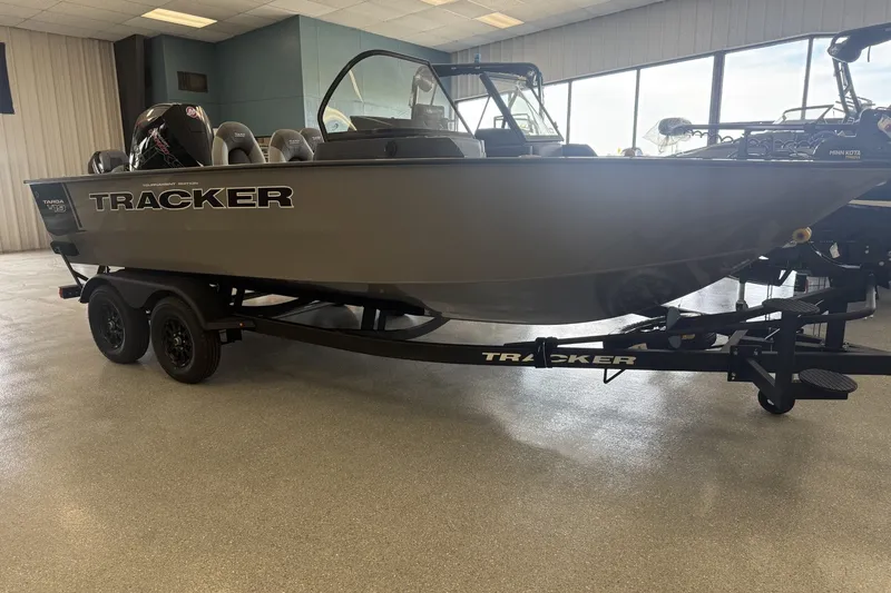 Slide: The Image of 2027 Tracker Targa V-19 Combo boat on trailer in showroom. - 2