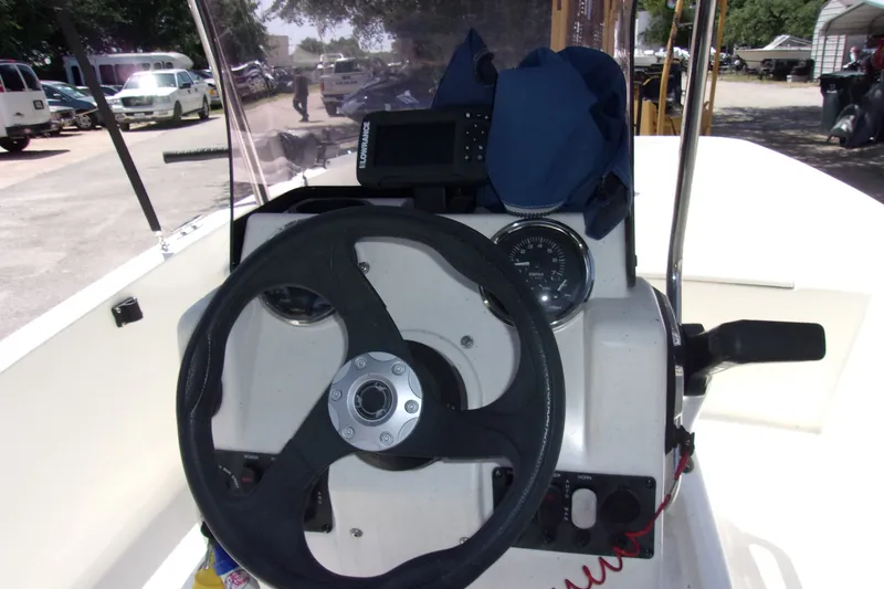 Slide: The Image of 2019 Mako Pro Skiff 17 CC steering console with navigation equipment and gauges. - 5