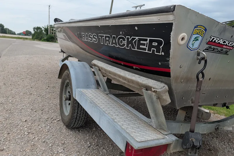 Slide: The Image of 1999 Tracker Pro Team 175 boat on trailer, parked on gravel road. - 4