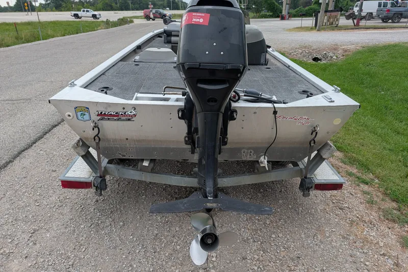 Slide: The Image of 1999 Tracker Pro Team 175 boat on trailer, rear view with motor, parked on roadside. - 5