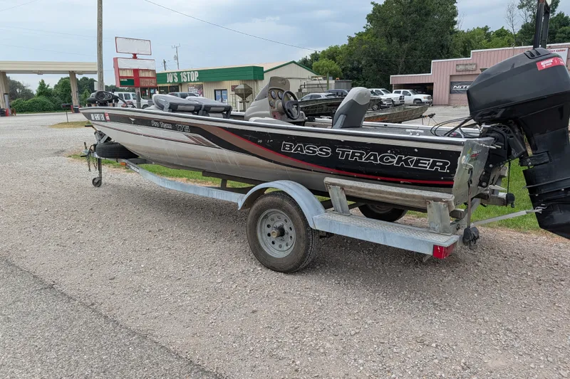 Slide: The Image of 1999 Tracker Pro Team 175 bass boat on trailer in parking lot. - 3