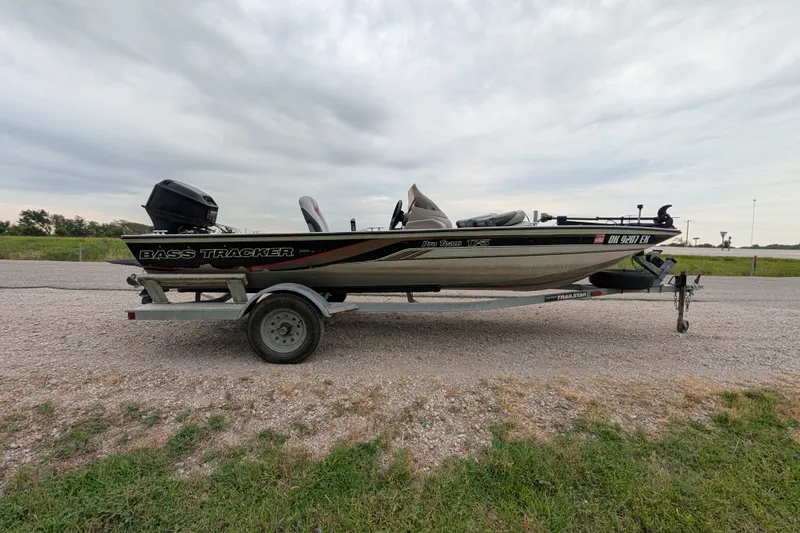 Slide: The Image of 1999 Tracker Pro Team 175 bass boat on trailer, parked on gravel road. - 8