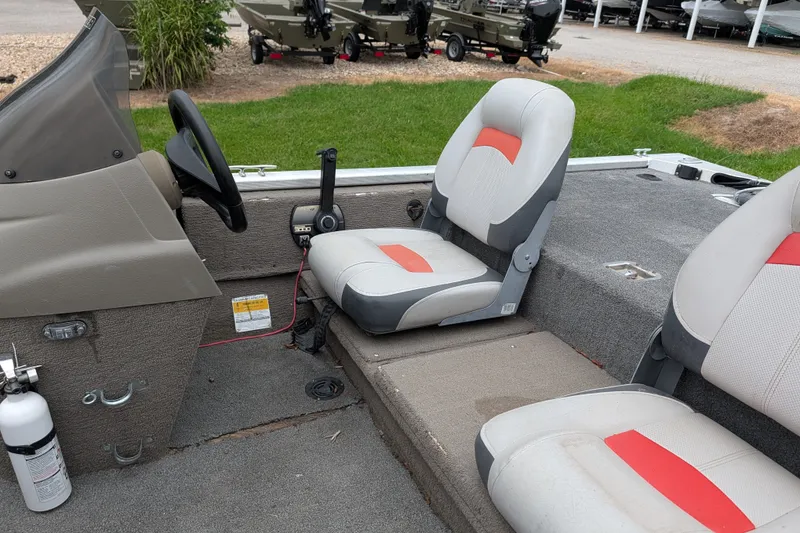 Slide: The Image of 1999 Tracker Pro Team 175 boat interior with steering wheel and seating. - 13