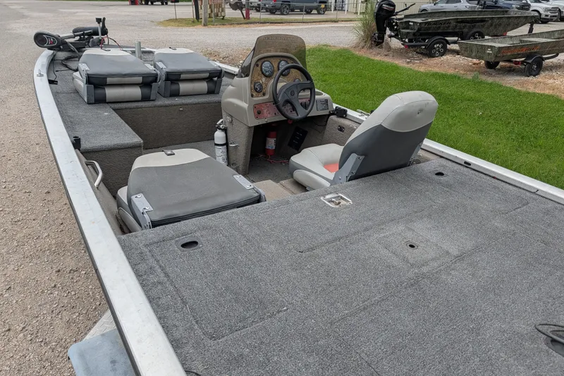 Slide: The Image of 1999 Tracker Pro Team 175 boat interior with steering wheel and seating. - 14