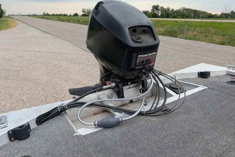 Slide: The Image of 1999 Tracker Pro Team 175 boat engine with cables on a road. - 20