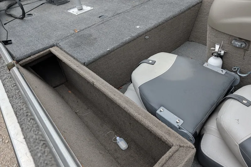 Slide: The Image of 1999 Tracker Pro Team 175 boat interior with open storage compartment and seating. - 18