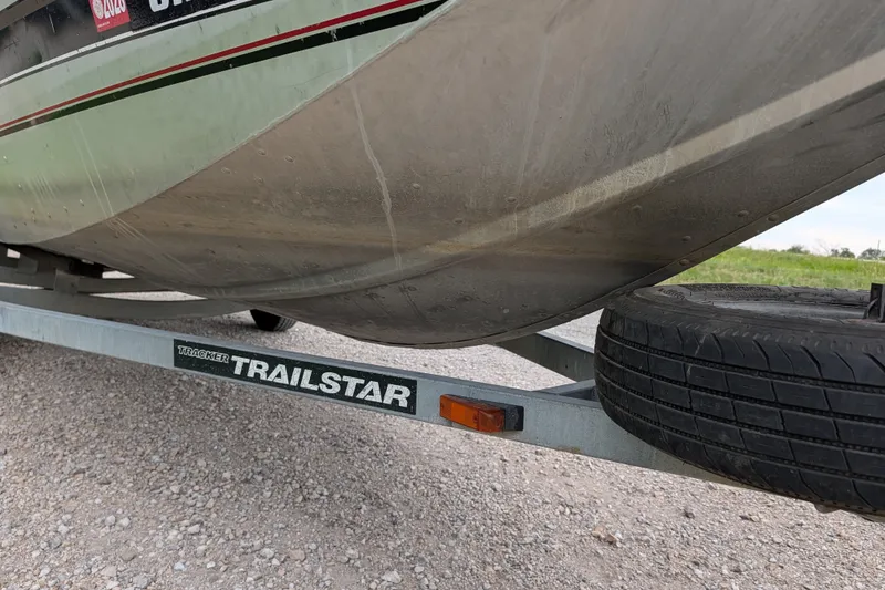 Slide: The Image of 1999 Tracker Pro Team 175 boat on Trailstar trailer, parked on gravel. - 10