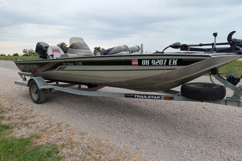 Slide: The Image of 1999 Tracker Pro Team 175 boat on a trailer, parked on gravel. - 9