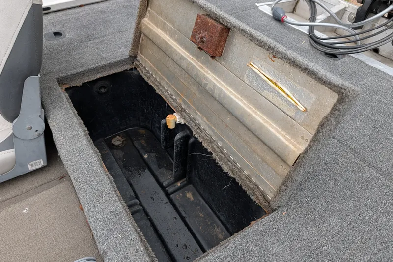 Slide: The Image of Open storage compartment in a 1999 Tracker Pro Team 175 boat interior. - 19
