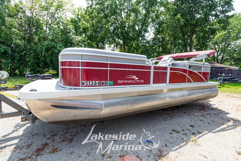 Slide: The Image of 2021 Bennington SV 22 Quad Bench pontoon boat on trailer, parked outdoors. - 9