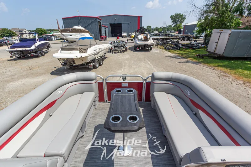 Slide: The Image of 2021 Bennington SV 22 Quad Bench pontoon boat at Lakeside Marina, surrounded by other boats. - 15