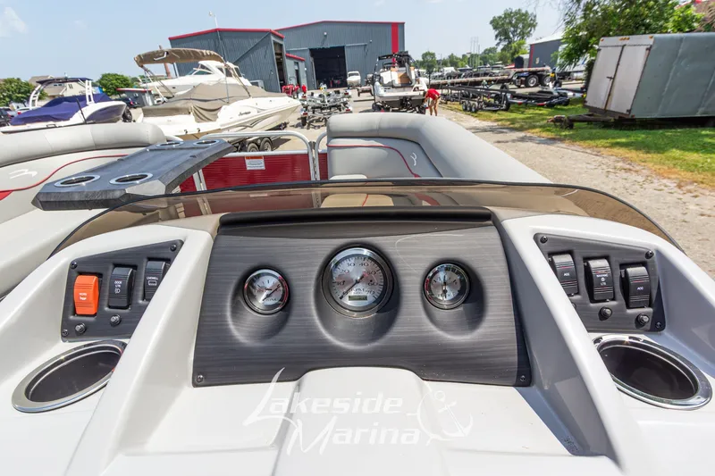 Slide: The Image of Dashboard view of a 2021 Bennington SV 22 Quad Bench pontoon boat at a marina. - 18