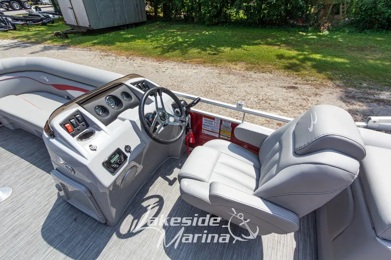 Slide: The Image of 2021 Bennington SV 22 Quad Bench boat interior with steering console and plush seating. - 17