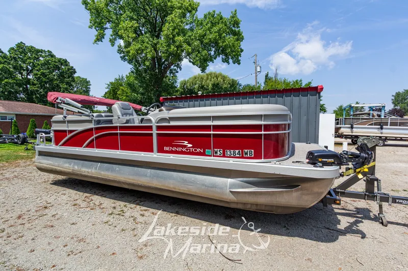 The Image of 2021 Bennington SV 22 Quad Bench pontoon boat in red, parked at Lakeside Marina. - 1