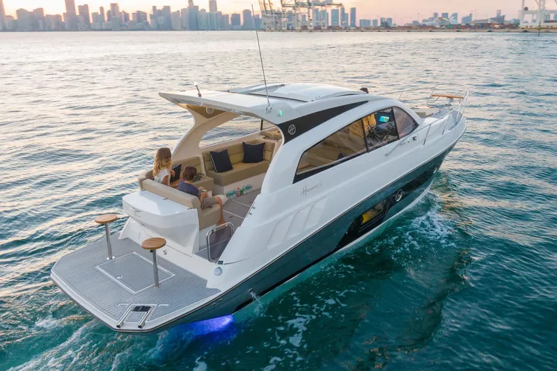 Slide: The Image of Luxury Hanover 375 yacht cruising near city skyline at sunset, 2026 model. - 3