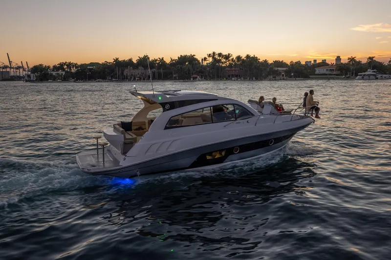 Slide: The Image of Luxurious 2026 Hanover 375 yacht cruising at sunset with passengers enjoying the view. - 74