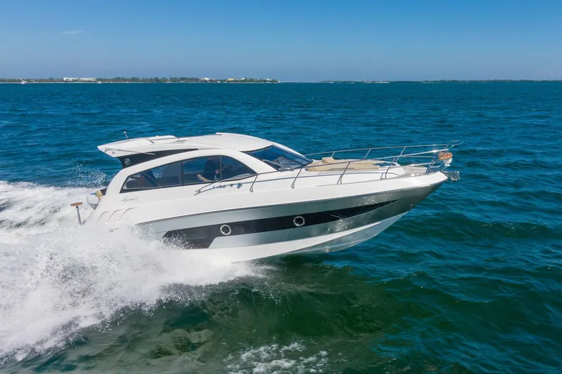 Slide: The Image of 2026 Hanover 375 yacht cruising on open blue sea under clear sky. - 11
