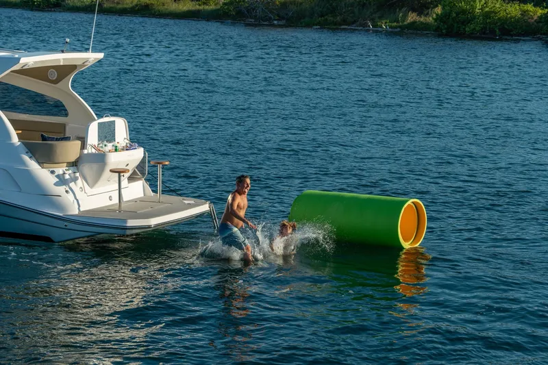 Slide: The Image of Man and dog playing near Hanover 375 yacht, 2026 model, on a sunny day. - 79