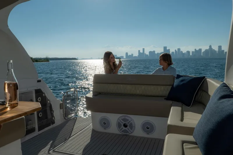 Slide: The Image of Couple enjoying a scenic view on a 2026 Hanover 375 yacht, with city skyline backdrop. - 40