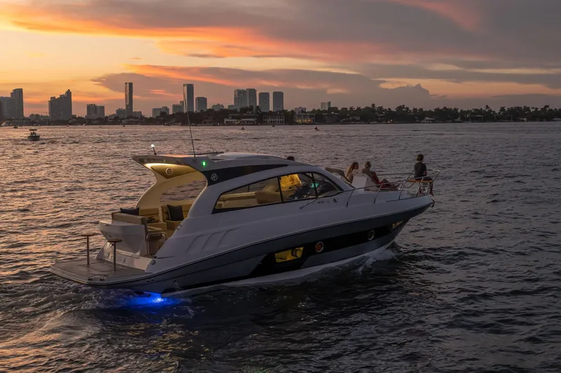 Slide: The Image of Luxurious Hanover 375 yacht cruising at sunset near city skyline, 2026 model. - 77