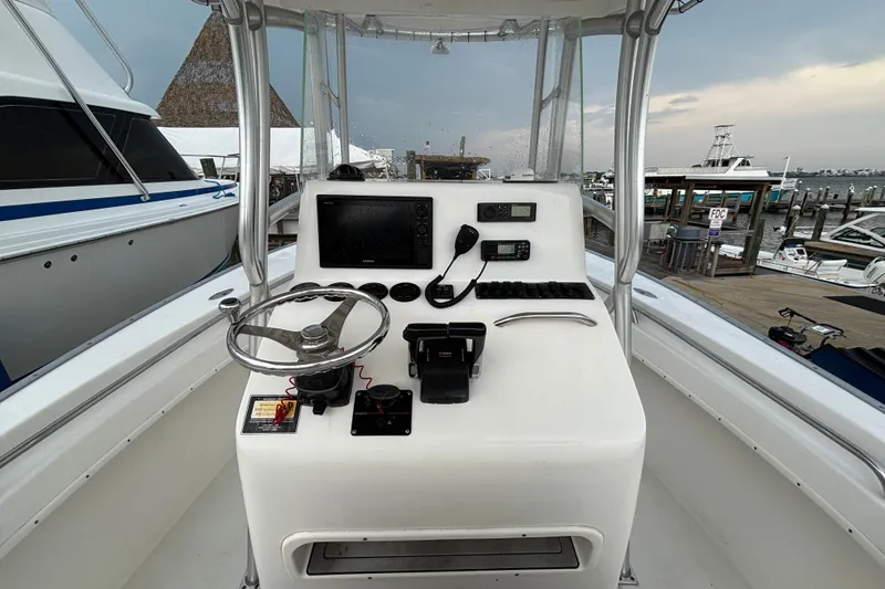 Slide: The Image of 2006 Cape Horn 24 boat console with steering wheel and navigation equipment at marina. - 14
