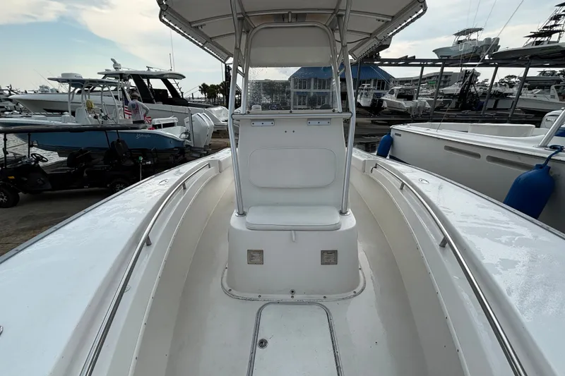 Slide: The Image of 2006 Cape Horn 24 boat interior view at marina, showcasing seating and helm. - 20