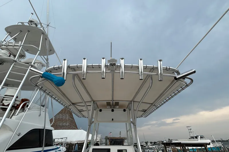 Slide: The Image of 2006 Cape Horn 24 boat with rod holders, docked under cloudy sky. - 13