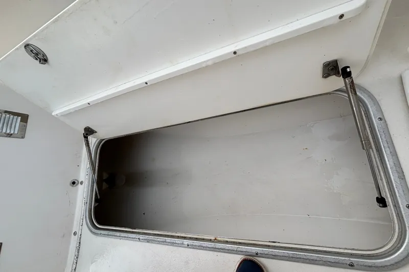 Slide: The Image of Open storage compartment on a 2006 Cape Horn 24 boat, showcasing interior space. - 25