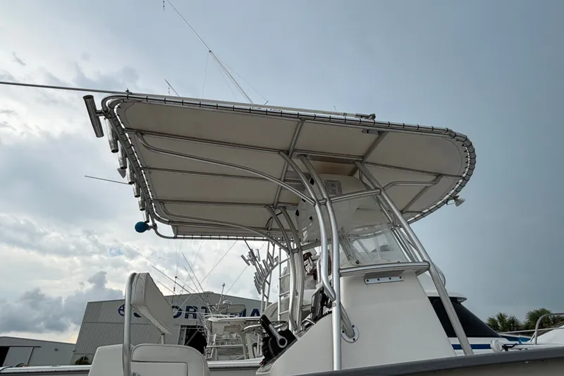 Slide: The Image of 2006 Cape Horn 24 boat with T-top and fishing rods against a cloudy sky. - 9