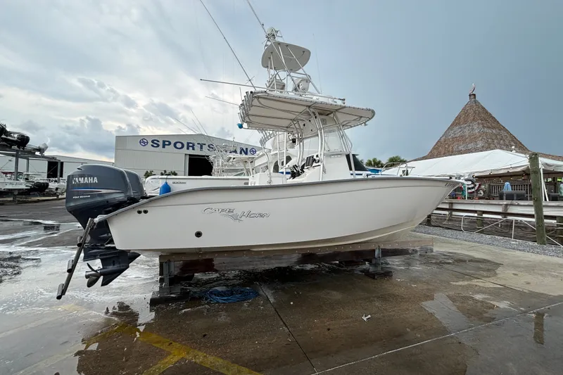 Slide: The Image of 2006 Cape Horn 24 boat with Yamaha engine at a marina, overcast sky. - 2