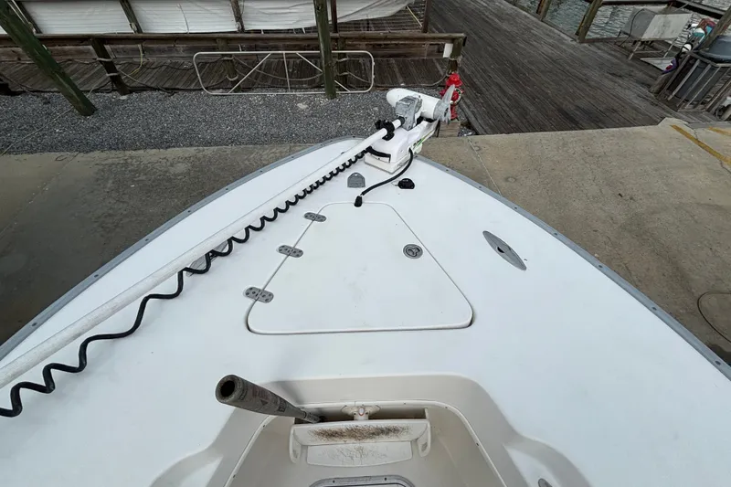 Slide: The Image of Bow view of a 2006 Cape Horn 24 boat docked, featuring a trolling motor. - 19