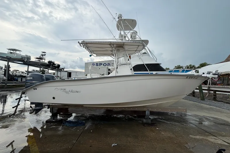 The Image of 2006 Cape Horn 24 boat on display at a marina, featuring a sleek white design. - 1
