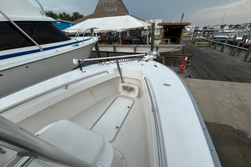Slide: The Image of 2006 Cape Horn 24 boat docked at marina with nearby buildings and overcast sky. - 18