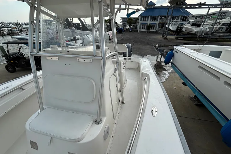 Slide: The Image of 2006 Cape Horn 24 boat docked at marina, featuring center console and seating. - 22