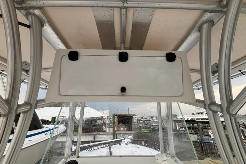 Slide: The Image of 2006 Cape Horn 24 boat console with storage compartment and marina view. - 17