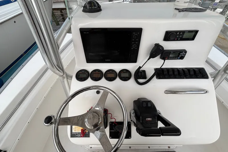 Slide: The Image of Helm of 2006 Cape Horn 24 boat with steering wheel, gauges, and navigation equipment. - 15