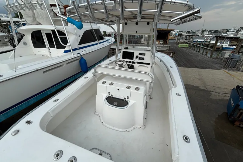 Slide: The Image of 2006 Cape Horn 24 boat docked, featuring spacious deck and control console. - 10