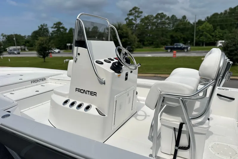 Slide: The Image of 2027 Frontier 2104 boat interior with steering console and seating, showcasing modern design. - 17