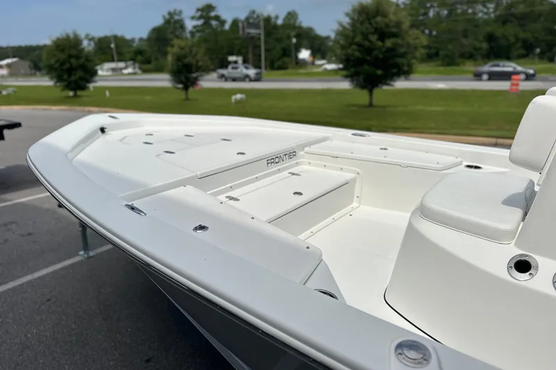 Slide: The Image of Frontier 2104 boat, 2027 model, displayed outdoors with sleek white design. - 16