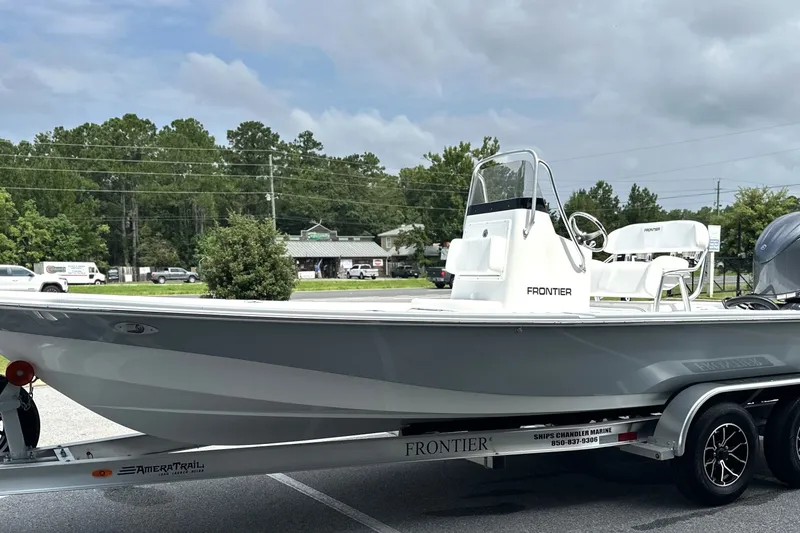 Slide: The Image of 2027 Frontier 2104 boat on trailer, parked outdoors, showcasing sleek design and modern features. - 24