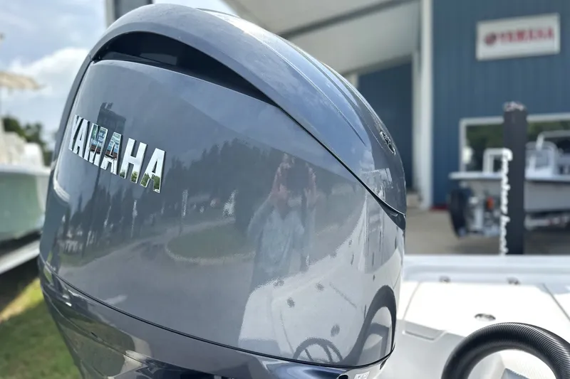 Slide: The Image of Close-up of a Yamaha boat engine at a dealership, featuring a Frontier 2104 model. - 25