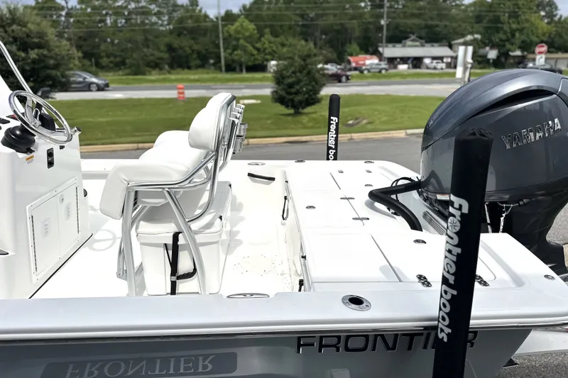Slide: The Image of Frontier 2104 boat, 2027 model, with Yamaha engine, parked outdoors. - 18