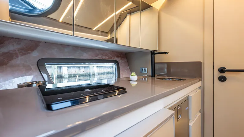 Slide: The Image of Modern kitchen interior in 2025 Hanover 415 RV with sleek countertops and appliances. - 13