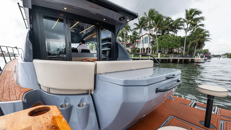 Slide: The Image of Luxurious Hanover 415 boat, 2026 model, by the water with palm trees in background. - 28