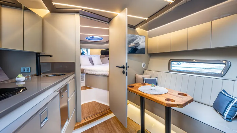 Slide: The Image of Luxurious interior of 2025 Hanover 415 yacht with modern kitchen and cozy seating area. - 11