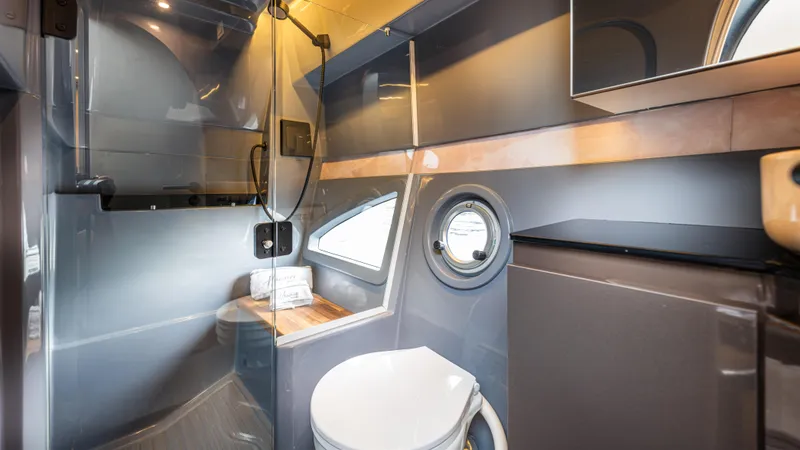 Slide: The Image of Modern bathroom interior in Hanover 415 RV, 2025 model, featuring sleek design and compact amenities. - 8